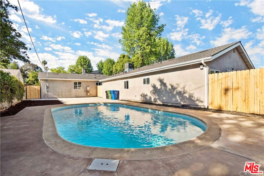 a view of a swimming pool with a back yard