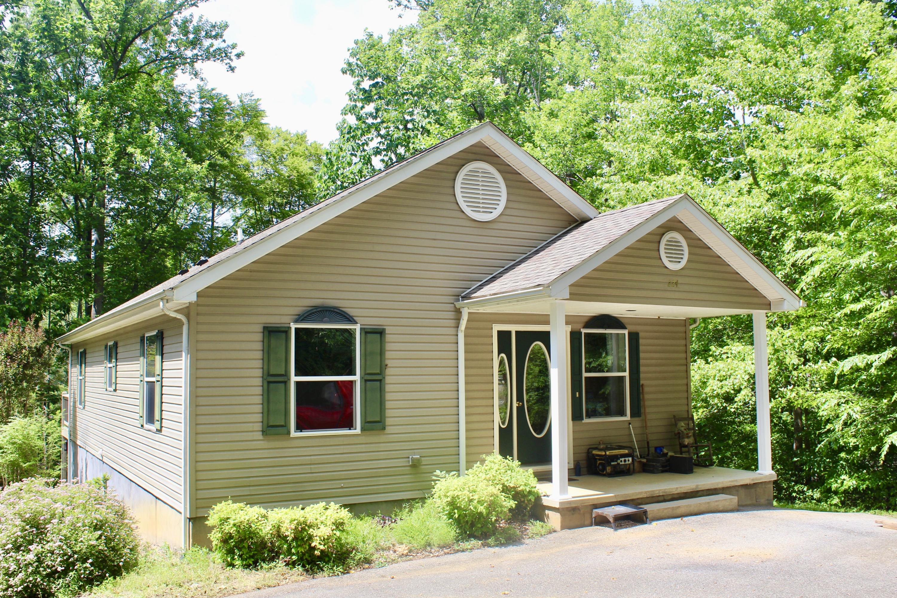 224 Board Mountain Road Goodview, VA 24095 - Photo 1 of 17 a front view of a house with a yard and garage