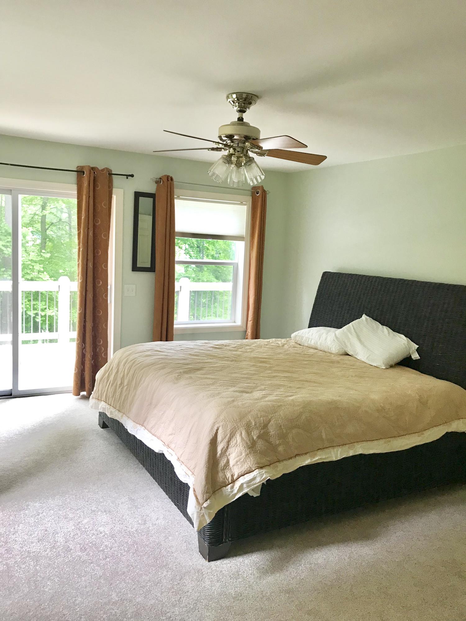 224 Board Mountain Road Goodview, VA 24095 - Photo 9 of 17 a spacious bedroom with a bed and a chandelier