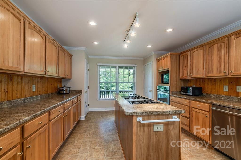 3182 Polk County Line Road Rutherfordton, NC 28139 - Photo 11 of 48 a kitchen with stainless steel appliances granite countertop a stove a sink a refrigerator and cabinets