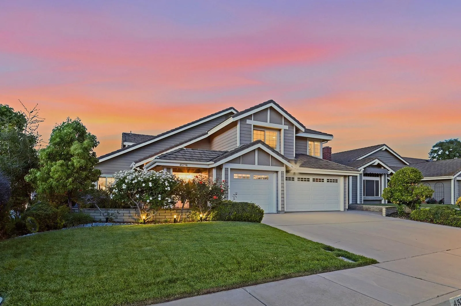 45774 Hopactong Street Temecula, CA 92592 - Photo 1 of 26 a front view of a house with a garden
