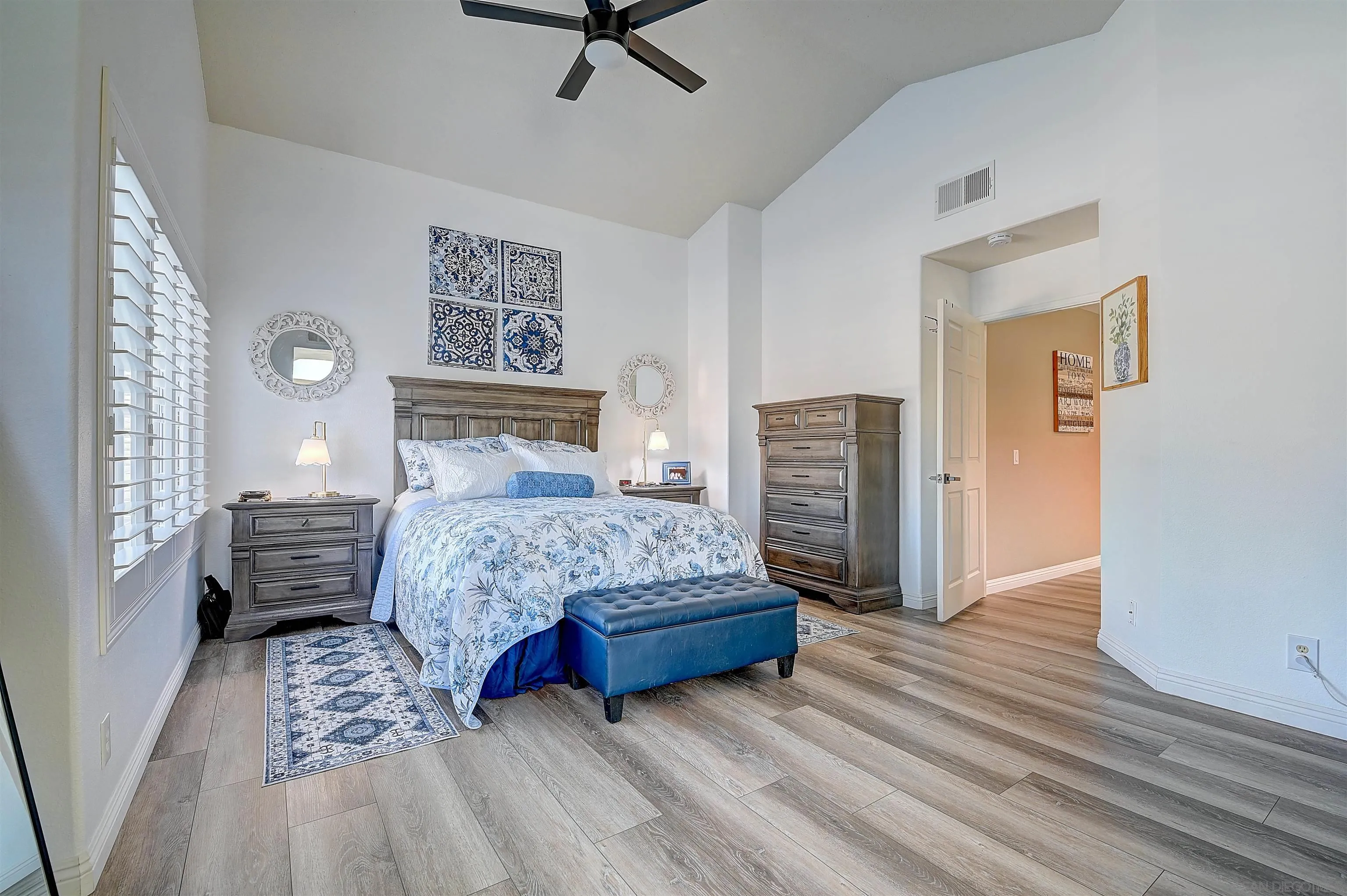 45774 Hopactong Street Temecula, CA 92592 - Photo 16 of 26 a bedroom with a bed and a chandelier