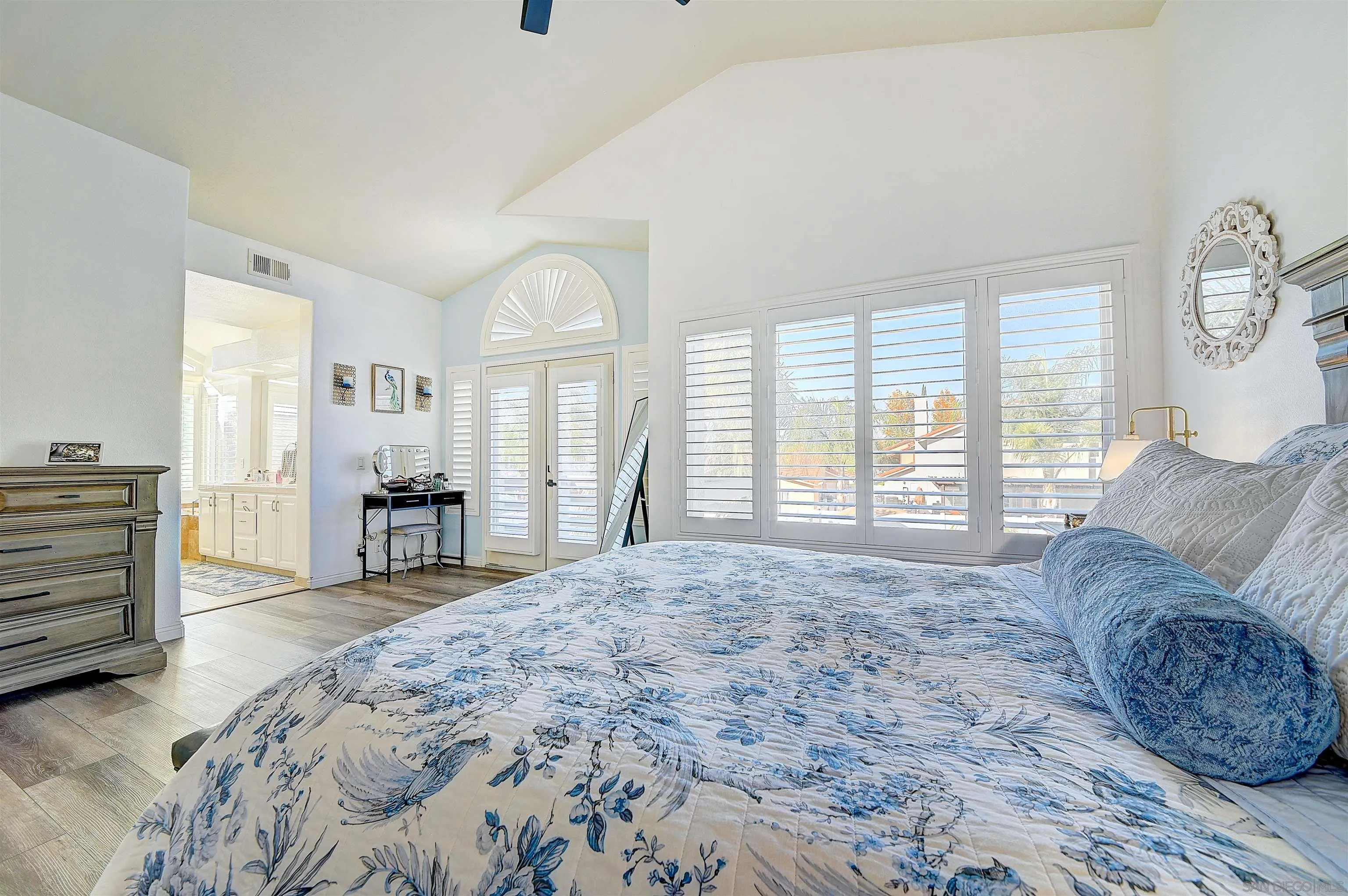 45774 Hopactong Street Temecula, CA 92592 - Photo 17 of 26 a spacious bedroom with a large bed and a large window