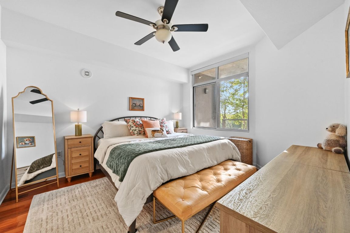 54 Rainey Street, Unit 416 Austin, TX 78701 - Photo 13 of 40 Bedroom with wood finished floors and ceiling fan