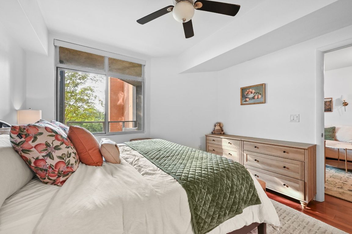 54 Rainey Street, Unit 416 Austin, TX 78701 - Photo 14 of 40 Bedroom with dark wood-style flooring and a ceiling fan