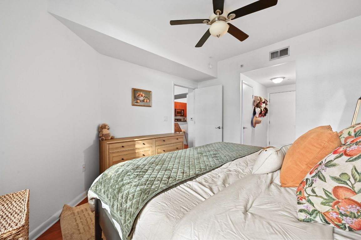 54 Rainey Street, Unit 416 Austin, TX 78701 - Photo 15 of 40 Bedroom with wood finished floors and ceiling fan