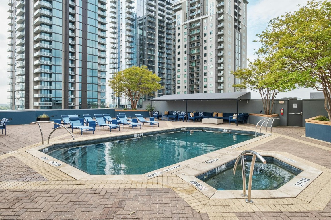 54 Rainey Street, Unit 416 Austin, TX 78701 - Photo 24 of 40 Community pool featuring a hot tub and a patio area