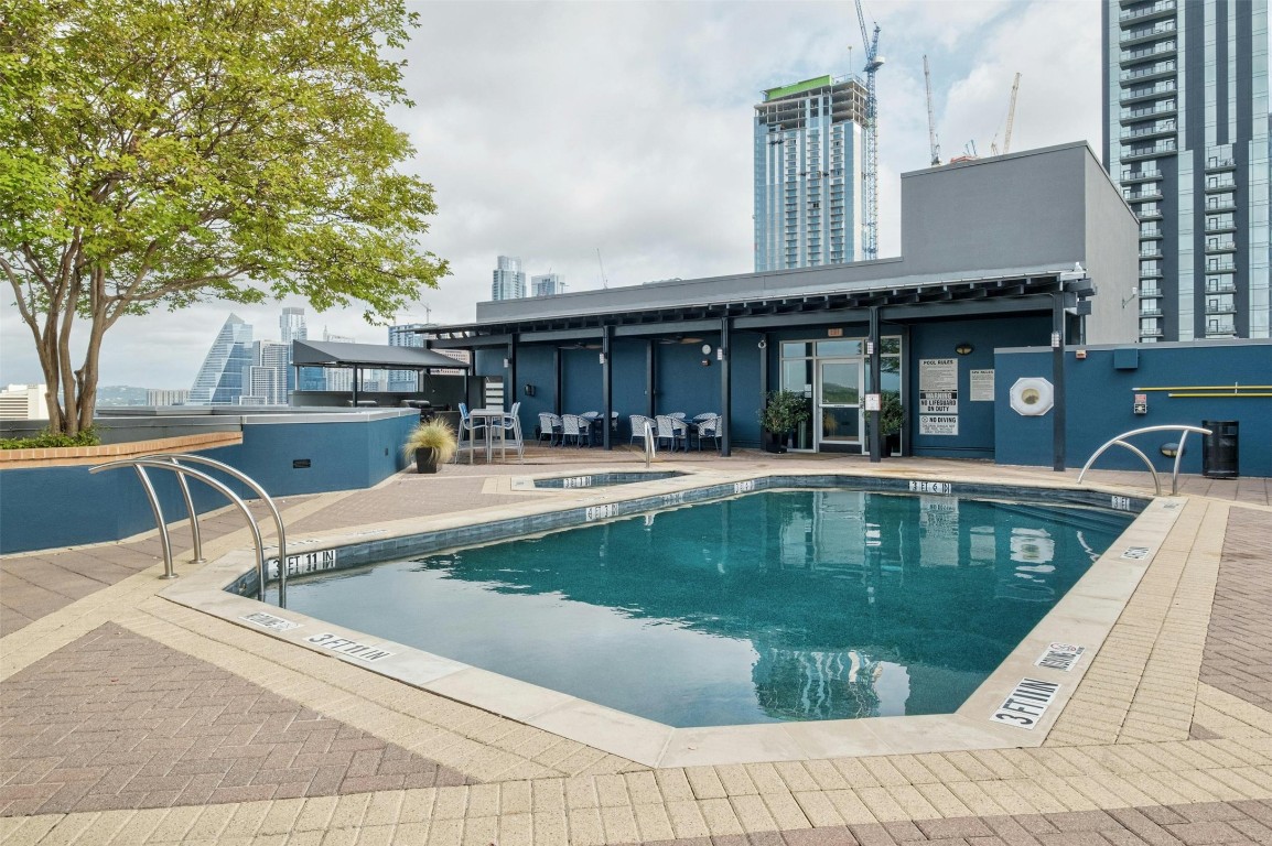 54 Rainey Street, Unit 416 Austin, TX 78701 - Photo 25 of 40 Community pool featuring a patio area, a community hot tub, and a view of city