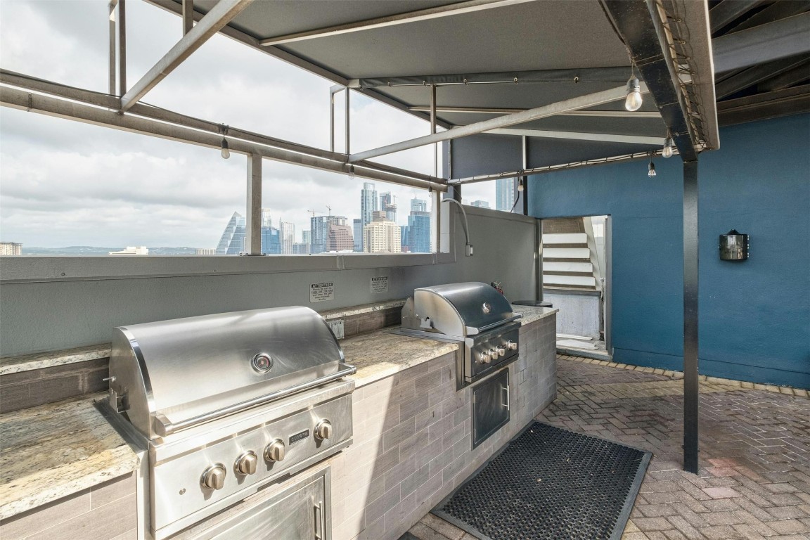 54 Rainey Street, Unit 416 Austin, TX 78701 - Photo 27 of 40 View of patio featuring a skyline view and area for grilling