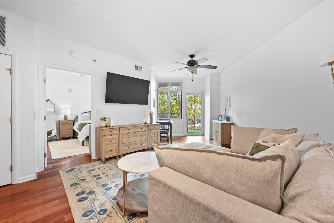54 Rainey Street, Unit 416 Austin, TX 78701 - Photo 8 of 40 Living area featuring wood finished floors and a ceiling fan