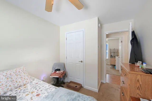 a bedroom with a bed and a flat tv screen on a dresser