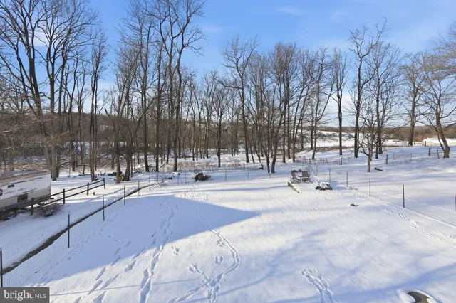 a view of a house with snow on the road