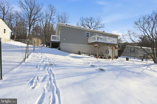a view of a house with a snow on the road
