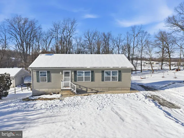 a view of a backyard with sitting area