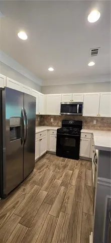 a kitchen with a stove a refrigerator and a sink