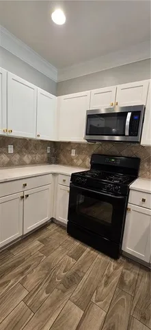 a kitchen with granite countertop a stove and a sink