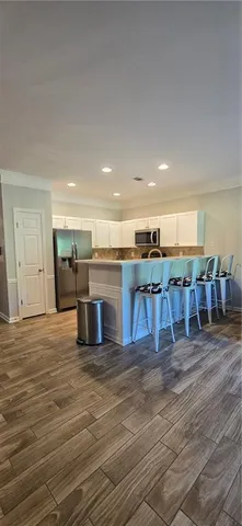 a kitchen with stainless steel appliances granite countertop a stove and a refrigerator
