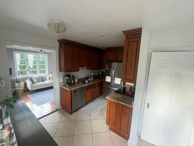 a kitchen with granite countertop a stove top oven a sink and a granite counter top