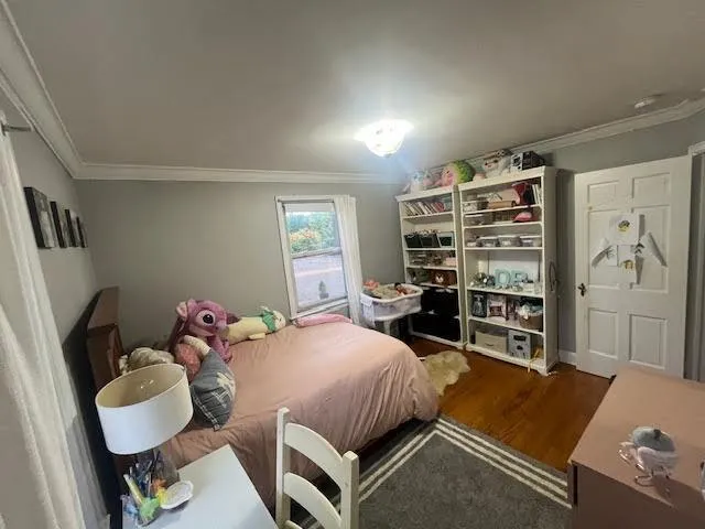 a bedroom with furniture and a wooden floor