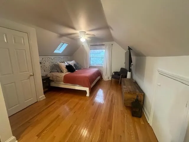 a bedroom with bed and a wooden floor