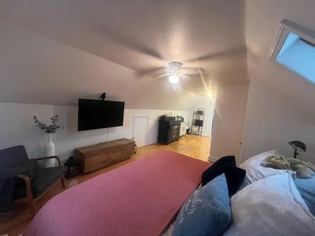 a bedroom with a bed and flat screen tv