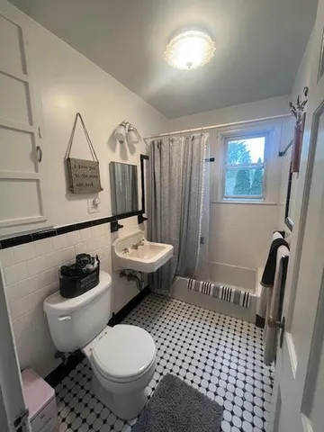 a bathroom with a sink toilet a mirror and vanity