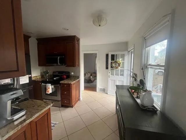 a kitchen with stainless steel appliances granite countertop a sink dishwasher stove and refrigerator