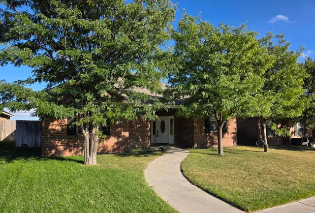front view of a house with a tree