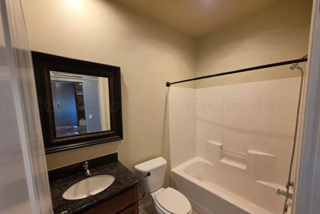 a bathroom with a toilet a sink and bathtub