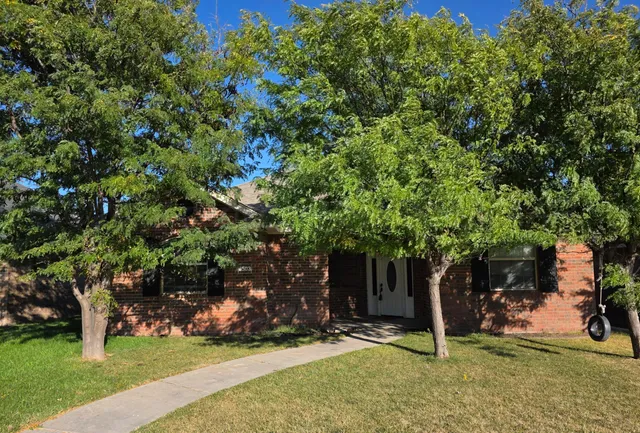 a tree in front of a house