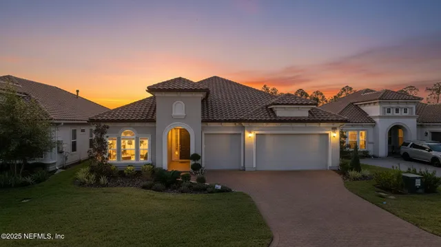 a front view of a house with a garden and plants