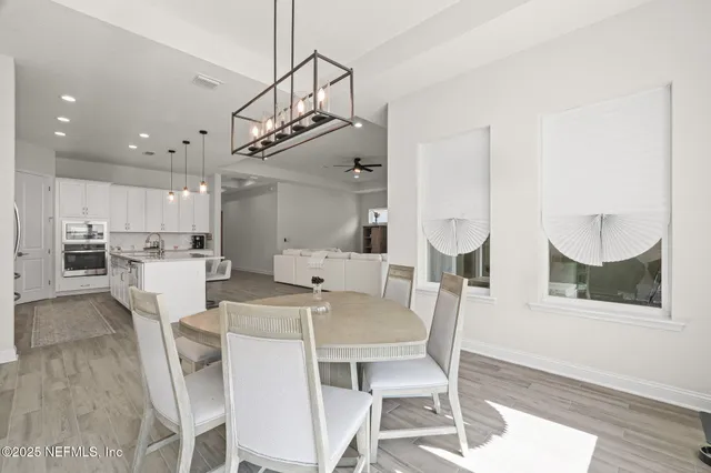 a kitchen with granite countertop white cabinets and a stove top oven