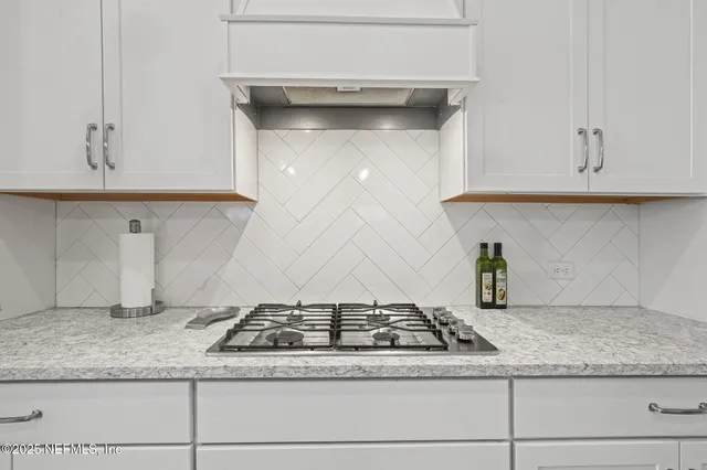 a dining room with furniture a chandelier and wooden floor