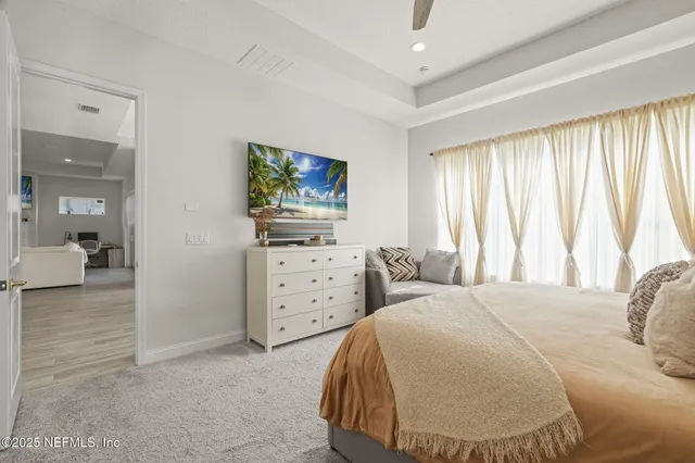 a bedroom with a bed and couch