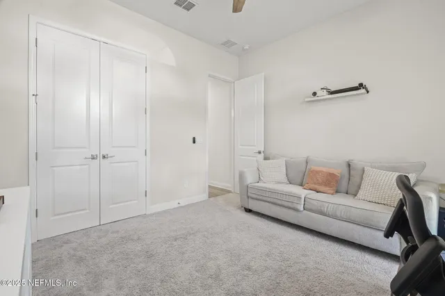 a bedroom with a bed and a potted plant