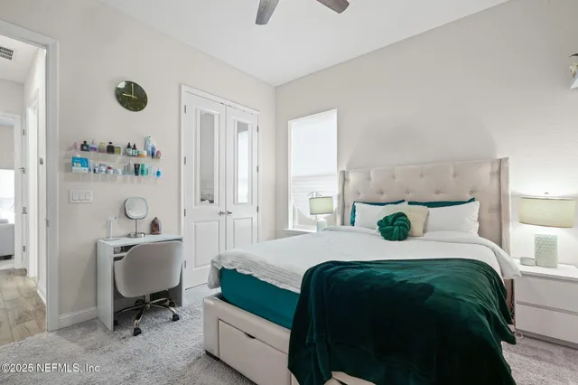 a bedroom with a bed and painting on the wall