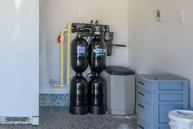 an aerial view of residential houses with outdoor space and river