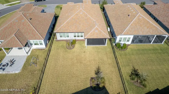an aerial view of a house with a yard and pool