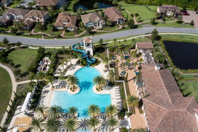 an aerial view of a house with a lake view