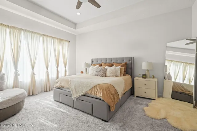 a spacious bedroom with a bed and a couch