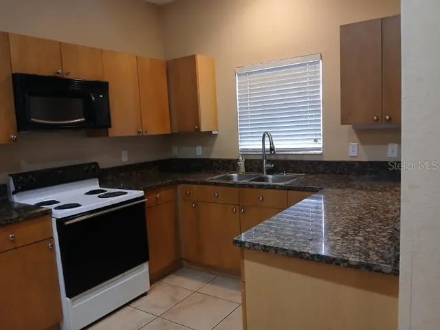 a kitchen with a stove and a microwave