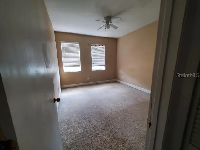 an empty room with windows and closet