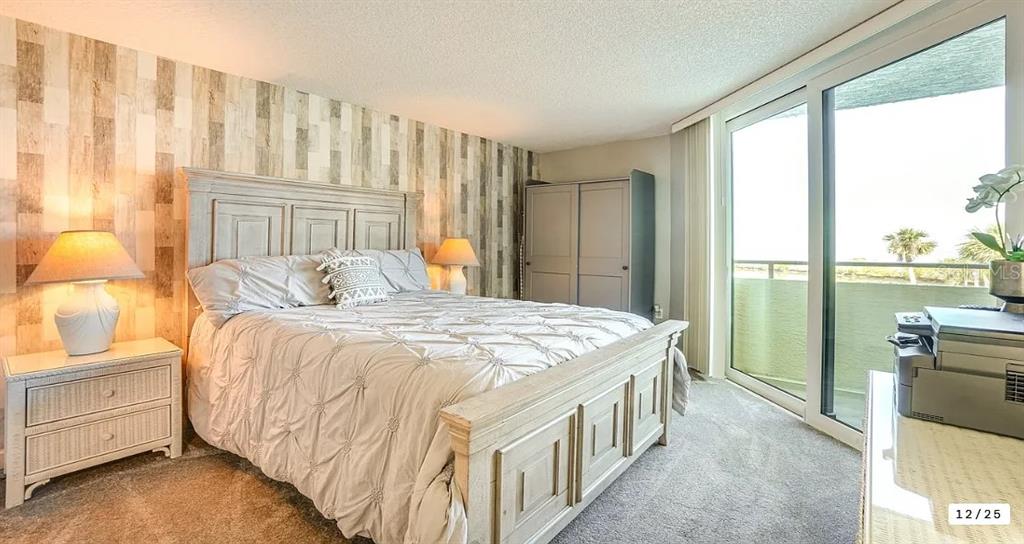 6009 Sea Ranch Drive, Unit 208 Hudson, FL 34667 - Photo 11 of 22 a bedroom with a bed and a night stand