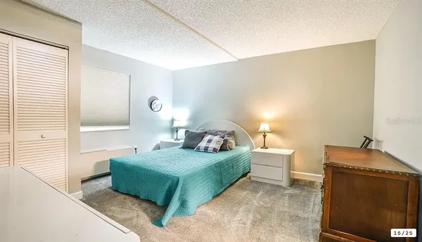 a bedroom with bed and window