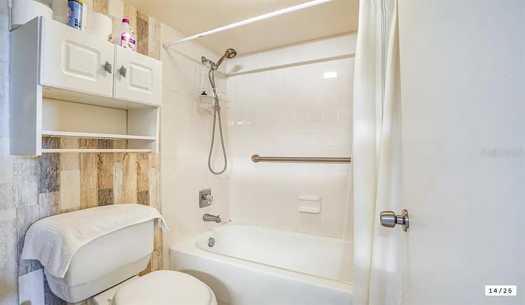 6009 Sea Ranch Drive, Unit 208 Hudson, FL 34667 - Photo 15 of 22 a bathroom with a granite countertop bathtub shower sink vanity and toilet