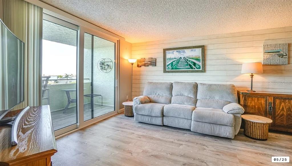 6009 Sea Ranch Drive, Unit 208 Hudson, FL 34667 - Photo 4 of 22 a living room with furniture and a floor to ceiling window