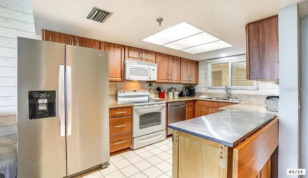 a kitchen with a refrigerator a sink and dishwasher