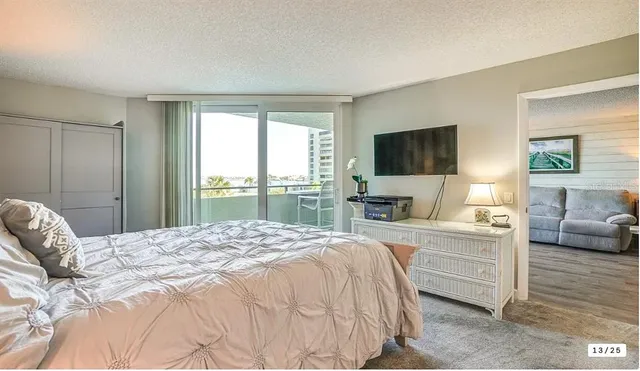 a bedroom with a large bed and a flat screen tv