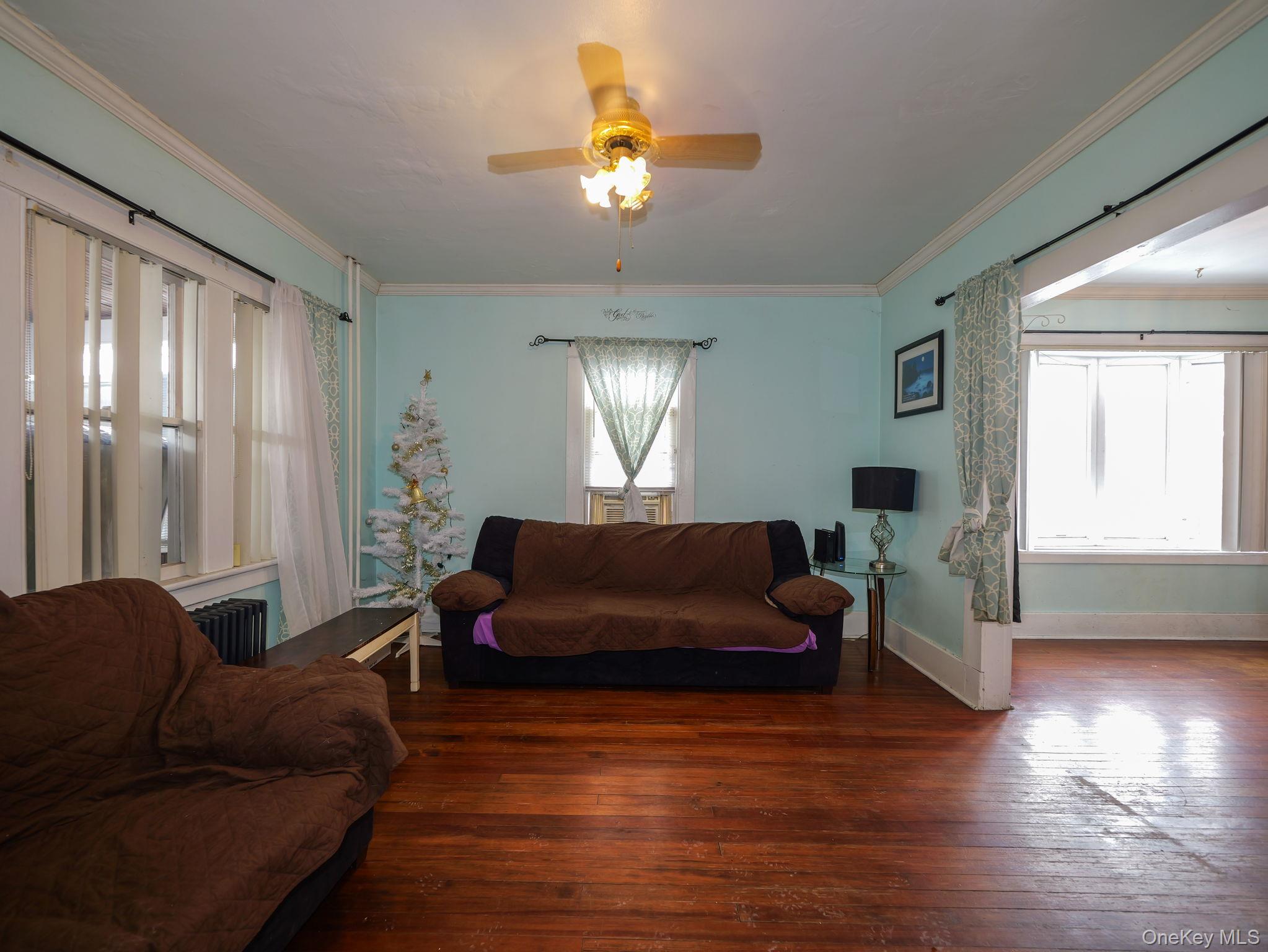 809 South Street Newburgh, NY 12550 - Photo 11 of 45 a living room with furniture and a chandelier