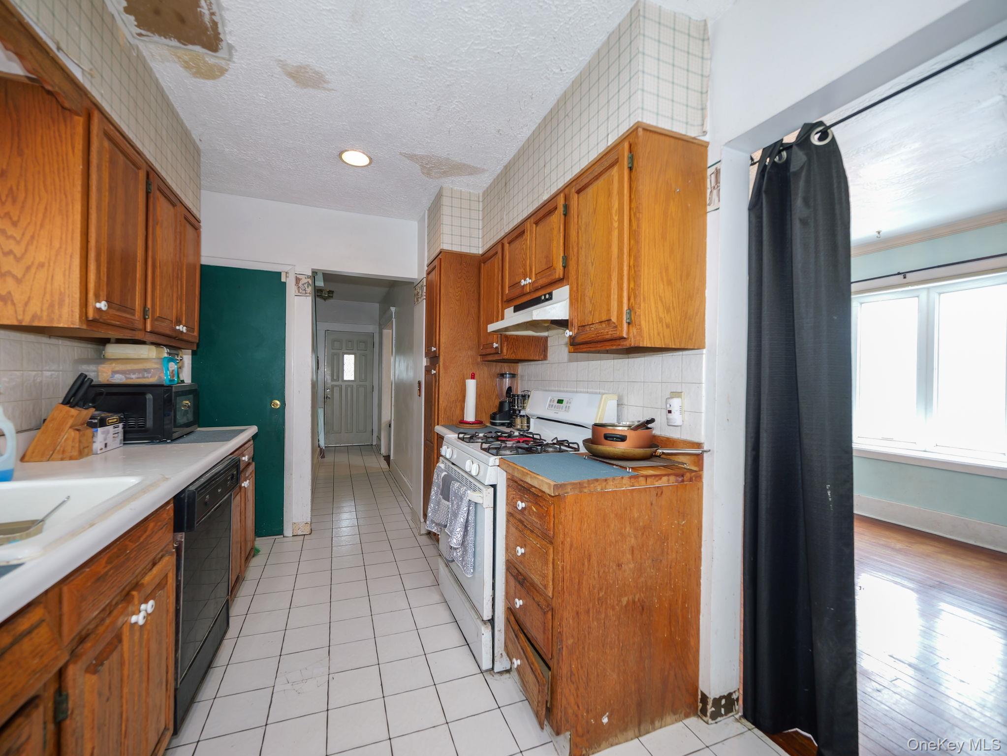 809 South Street Newburgh, NY 12550 - Photo 14 of 45 a kitchen with stainless steel appliances granite countertop a refrigerator a stove and a wooden cabinets